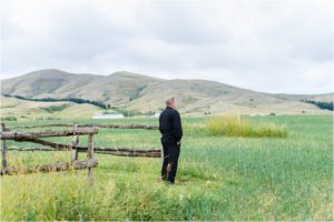 bride and groom taking portraits in mountain montana